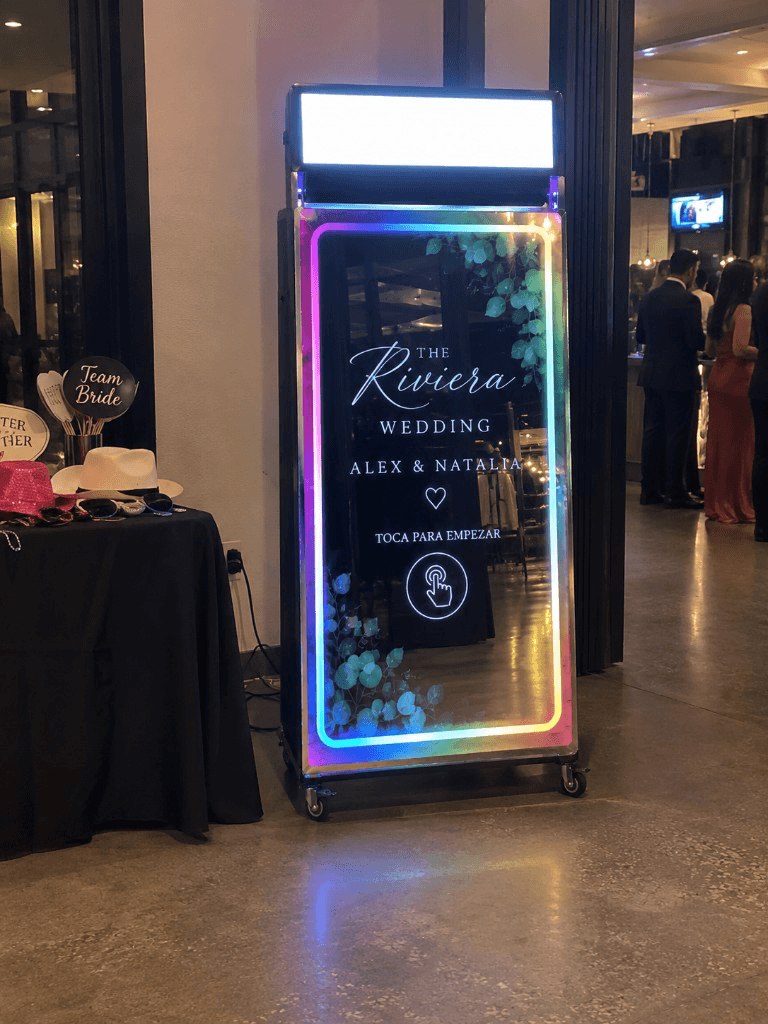 ZelphyPix 70-inch Mirror Photo Booth with rainbow LED frame at a wedding